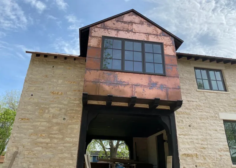 Copper metal panel facade on a stone building for Skylight Installation in La Junta